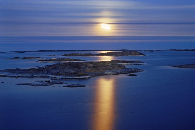 sweden, full moon over stora nassa island group in stockholm archipelago