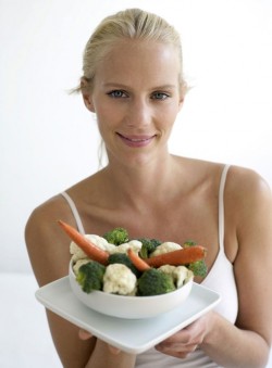 portrait of woman holding a bowl of mixed vegetables