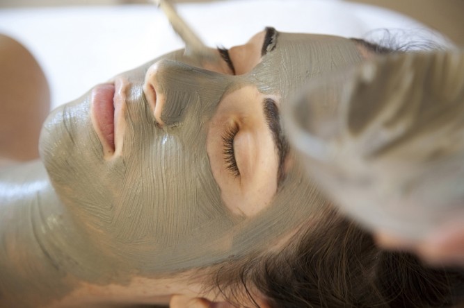 woman getting facial mask